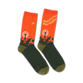 Pair of crew socks in orange and dark green.  The socks feature a dandelion graphic and the words "And Still I Rise" by Maya Angelou.