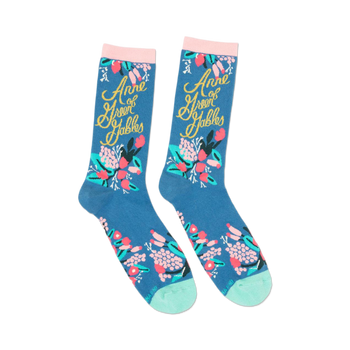 pair of blue socks with "anne of green gables" written in gold script and pink flowers.