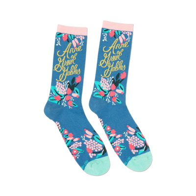 pair of blue socks with "anne of green gables" written in gold script and pink flowers.