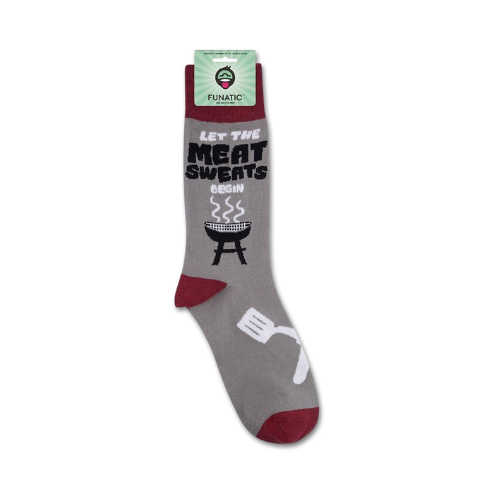 A pair of gray socks with red toes, heels, and trim. The socks have the words 