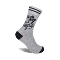 Grey crew socks with black stripes at the top and a black and white tattoo-style graphic of a dagger through a heart that says 'Bad Ass With A Good Ass'.