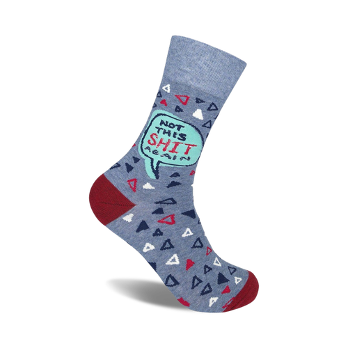 Crew socks in blue with a teal speech bubble saying 'Not This Shit Again'.  The sock also features small red and white triangles on a blue background. 