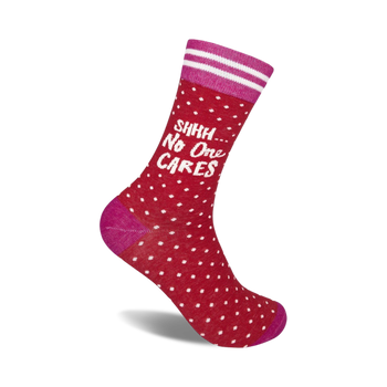 red socks with white polka dots and the words '{shhh... no one cares}' on the leg; pink toe, heel, and top; two pink stripes; crew length; men and women. 