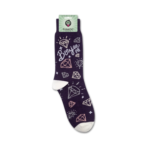 A pair of purple socks with white toes and heels. The socks have a repeating pattern of pink and white diamonds with the word 