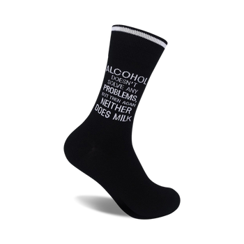 black socks with white text reading "alcohol doesn't solve any problems, but then again neither does milk". crew length.  