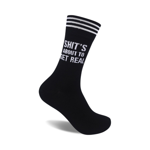 Black crew socks with white stripes at the top and the phrase 'Shit's About To Get Real' in white lettering.