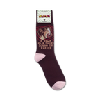 Lifestyle product shot showing maroon 'A Yawn Is A Silent Scream For Coffee' socks on a person's feet.