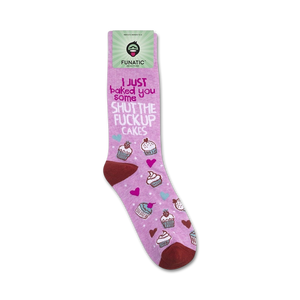 A pair of pink socks with a cupcake pattern and the words 