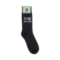 A close-up view of 'The Groom' socks still on the store packaging.