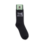 A close-up view of 'The Groom' socks still on the store packaging.