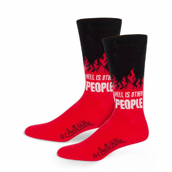 A pair of crew socks in red and black.  The socks feature a design of flames and the text 'Hell is Other People'.