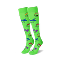 Pair of bright green knee-high socks with a repeating pattern of Teenage Mutant Ninja Turtle heads. Each Turtle's signature bandana is visible.