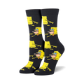 Pair of black crew socks featuring a repeating pattern of yellow Spongebob Squarepants in a prehistoric pose. 