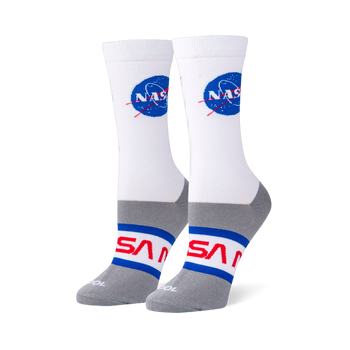 White crew socks on foot forms featuring the blue NASA meatball logo on the calf and red NASA worm text on a grey foot base.