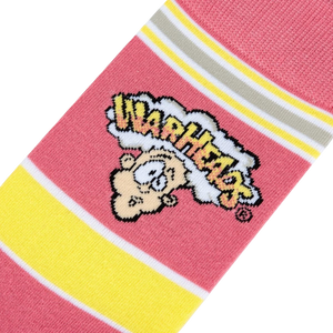 A pink sock with yellow and white stripes and a cartoon character on the leg. The cartoon character is yellow with a pink face and black eyes and is wearing a yellow hat. The word 