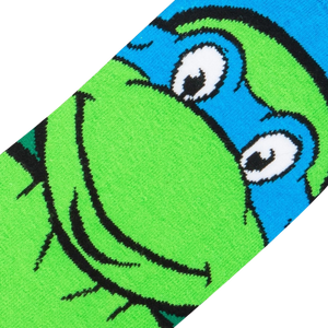 A close up of a green sock with a blue and white Teenage Mutant Ninja Turtle face on it.