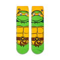 Pair of Michelangelo Teenage Mutant Ninja Turtles socks shown against a white background.