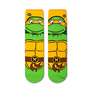 A close up of a sock with the face of Michelangelo from the Teenage Mutant Ninja Turtles on it. The sock is green with yellow and white details.