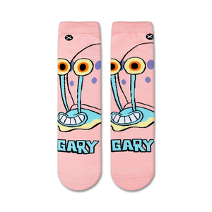 A close up image of a pair of socks with a light pink background and a cartoon character, Gary the Snail from Spongebob Squarepants. Gary is smiling with his tongue out and has two large eyes.