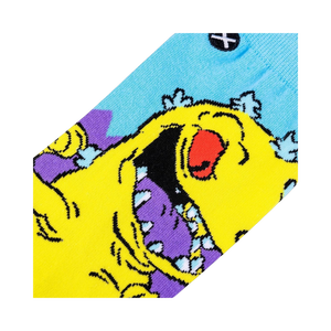 Close-up detail shot of the Rugrats Reptar sock design, highlighting the vibrant yellow, purple, and light blue colors.