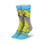 Pair of crew socks featuring Reptar from Rugrats.  Yellow dinosaur design on a light blue background with purple accents.