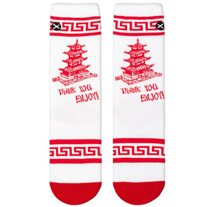 Flat lay of two white crew socks with red pagoda graphic, 'Thank You Enjoy!' text, and geometric red cuff.