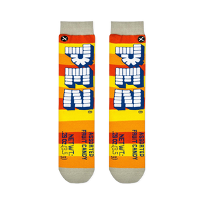 Flat lay of two Pez socks showing orange and yellow stripes, vertical block logos, and printed net weight details at the toe.