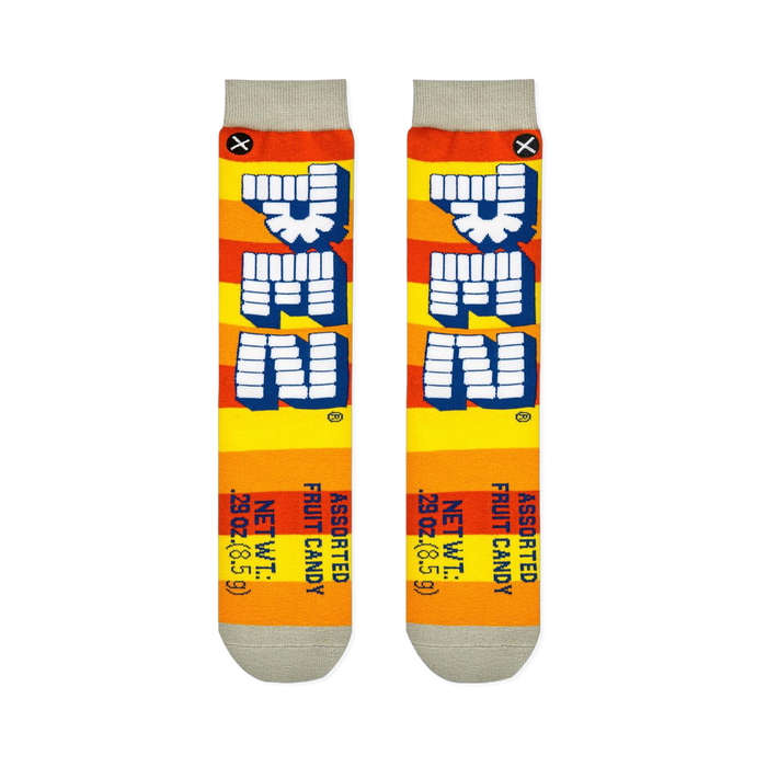 Flat lay of two Pez socks showing orange and yellow stripes, vertical block logos, and printed net weight details at the toe.
