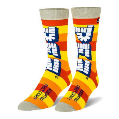 Crew socks with yellow and orange stripes, a large vertical white Pez logo, and light grey details on the toe and cuff.