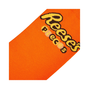 Close-up detail shot of the Reese's Pieces logo on the orange part of the sock.