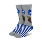 Pair of crew socks. Gray background with a York Peppermint Pattie design, blue stripes at the cuffs. 