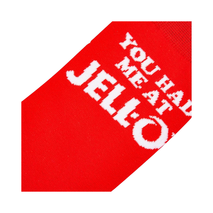 Close-up detail shot highlighting the 'You Had Me At Jell-O' text on the red sock.