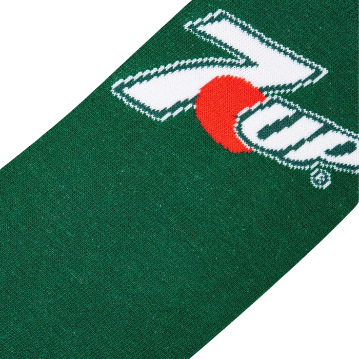 A close up of a green sock with a red circle and white seven on it.