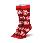 Pair of red crew socks with a repeating Dr Pepper logo pattern. White logo on red background.