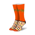 Pair of crew socks in orange, brown, and cream. Features Reese's Pieces logo and polka dot pattern.