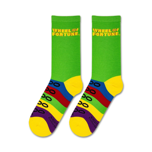 A pair of green socks with a Wheel of Fortune logo in yellow on the top cuff. Under the logo are four horizontal colored stripes in red, orange, yellow, and blue.