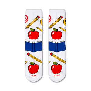 A pair of white socks with a pattern of red apples, yellow pencils, and blue books. The word 