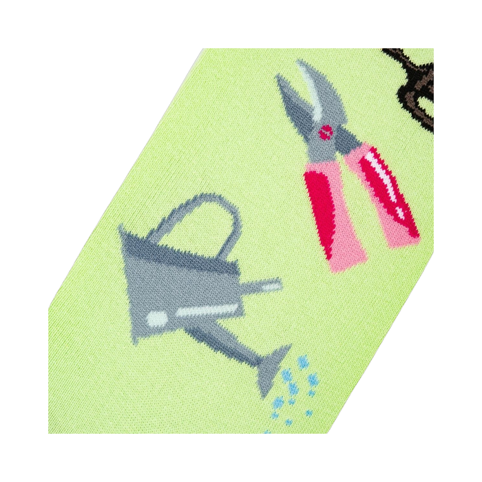 Detailed close-up of the sock design, focusing on a watering can and pink gardening shears.