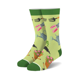 womens gardening crew socks - green background with pink, yellow and orange flowers, rakes, shovels, watering cans and flower pots   