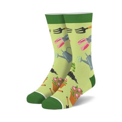 womens gardening crew socks - green background with pink, yellow and orange flowers, rakes, shovels, watering cans and flower pots   