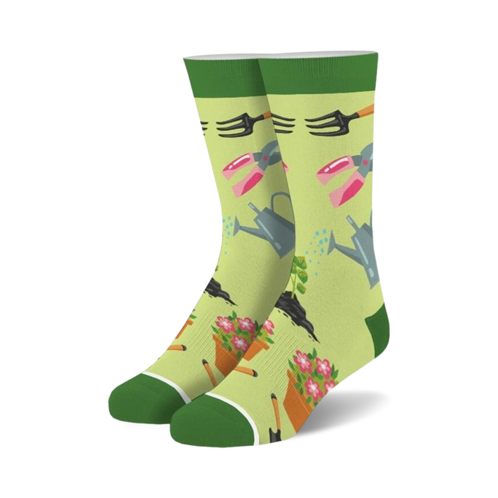 womens gardening crew socks - green background with pink, yellow and orange flowers, rakes, shovels, watering cans and flower pots   