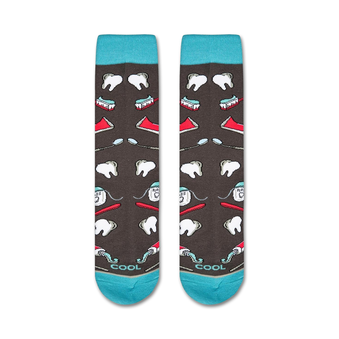 A pair of gray socks with a pattern of red and white toothbrushes, toothpaste, and floss.