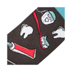 Close-up detail shot of the sock fabric, showing the crisp and detailed print of the dental tools and teeth.