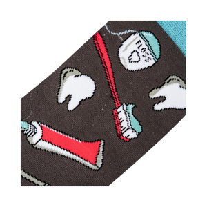 Close-up detail shot of the sock fabric, showing the crisp and detailed print of the dental tools and teeth.