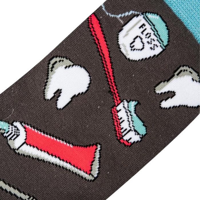 A pair of gray socks with a pattern of red and white toothbrushes, toothpaste, and floss.