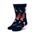 Pair of navy blue crew socks with red and gray barber-themed designs: barber chairs, scissors, and shaving brushes.