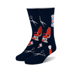 Pair of navy blue crew socks with red and gray barber-themed designs: barber chairs, scissors, and shaving brushes.