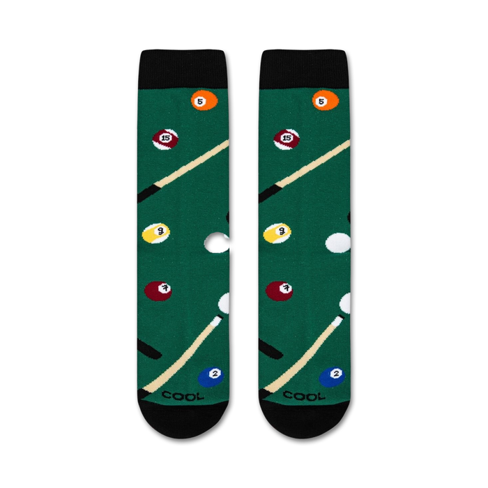 A green pool table sock with a pool cue and billiard balls in the background.
