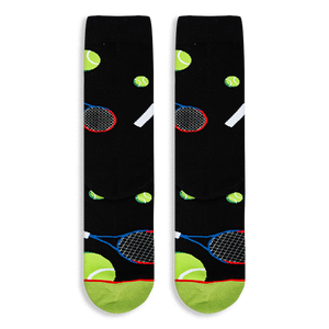 Flat lay of black socks showing the tennis ball and racket pattern, with a neon green toe and red stripe at the bottom.