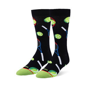 Black crew socks featuring a pattern of neon green tennis balls and blue and red rackets with a bright green toe cap.